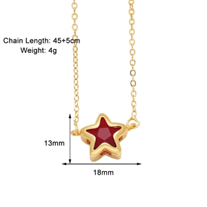 Detail view of a gold star necklace with red enamel and dimension labels 18x13mm