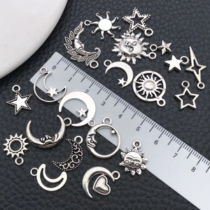 Detailed scale view of silver celestial moon and star alloy charms for jewelry making