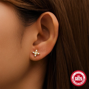 S925 sterling silver gold star stud earrings with opal and clear stones on female model