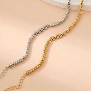 Close-up of gold and silver beaded MAMA bracelets with lobster clasp and extender