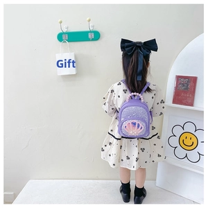 Detail of purple sequin toddler backpack with shell decor and pearl handle