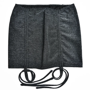 Detail of glitter fabric texture and adjustable drawstring ties on bodycon mini skirt