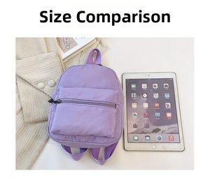 Purple nylon mini backpack shown next to an iPad for size comparison on a white desk