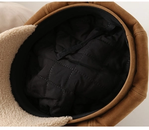 Detailed view of winter newsboy hat featuring faux suede exterior and warm fleece lining
