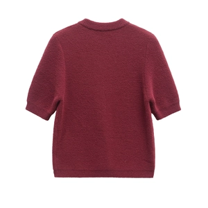 Detail of wine red knit top featuring ribbed crew neck and fine wool blend texture