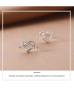 Close-up of 925 sterling silver heart-shaped stud earrings with micro-pave cubic zirconia