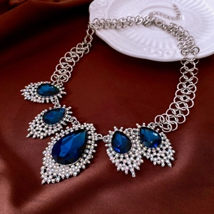 Macro shot of French luxury blue teardrop pendant necklace with sparkling crystal inlay