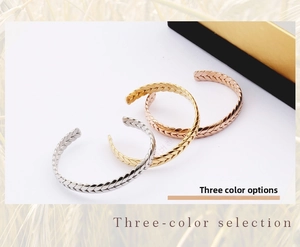 Detailed view of stackable wheat grain texture cuffs in silver, gold, and rose gold