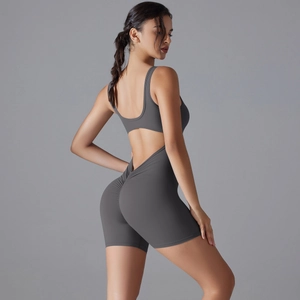 Detail of grey yoga bodysuit featuring a ruched scrunch butt design and open back detail