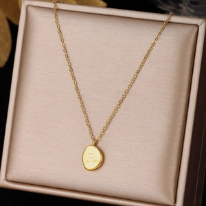Minimalist gold titanium steel necklace with engraved oval bean pendant in a gift box
