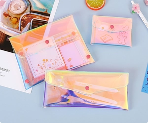 Detailed view of three iridescent PVC organizers in various sizes on light blue background