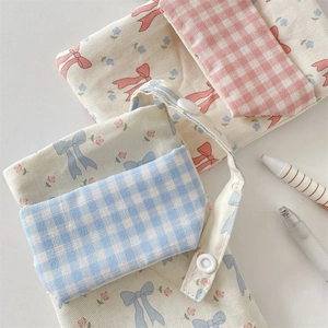 Close-up of floral canvas nurse pocket protector with pink and blue checkered patterns