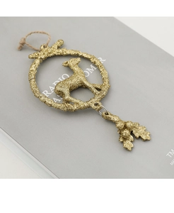 Close-up of golden reindeer Christmas ornament with glitter finish and rustic hemp cord
