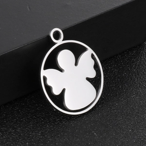 Detailed view of a silver hollow angel silhouette pendant on a black textured surface