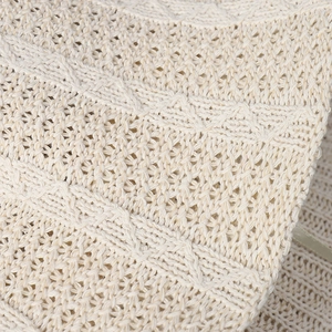 Detailed close-up of intricate hollow crochet knit patterns on an off-white bucket hat