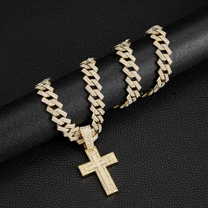 Golden Cuban link chain necklace with a iced-out cross pendant on black background