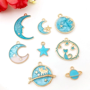 Detailed set of 8 gold alloy star and moon charms with light blue enamel finish