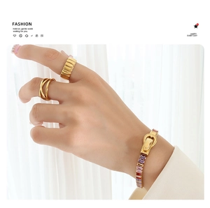 Detailed shot of gold plated titanium bracelet with colorful zircons and magnetic buckle