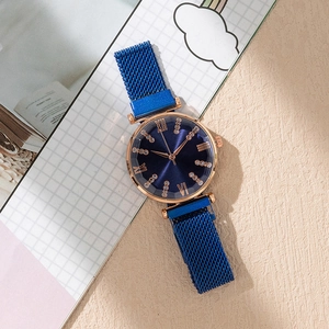 Close-up of luxury blue sunray dial watch with rose gold case and magnetic mesh strap