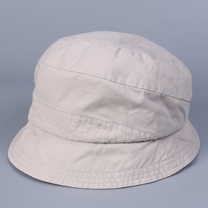 Detail of multi-row stitching on the brim of a minimalist beige washed cotton bucket hat