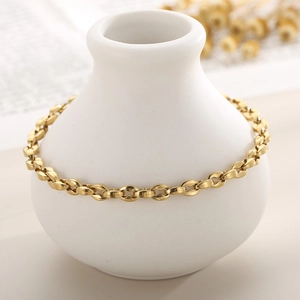 Minimalist 18K gold plated titanium steel geometric link anklet on a white ceramic vase
