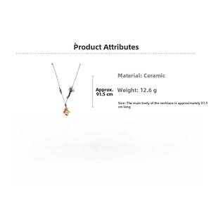 Detailed view of ceramic kitten pendant with wax cord, wood beads and size specifications