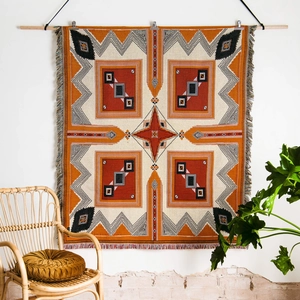 Detail of bohemian geometric woven picnic blanket with tassels for outdoor camping decor