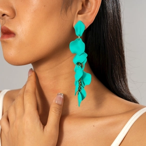 Detail of turquoise petal layered drop earrings with gold rings on professional model