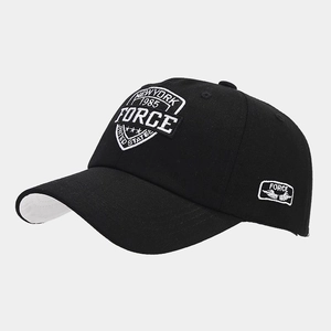 Detail of black cotton baseball cap showing white New York 1985 shield embroidery