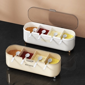 Four-compartment seasoning box set with spoons in white and beige on marble surface