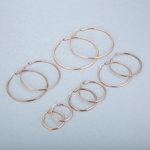 Set of 6 pairs rose gold stainless steel hoop earrings in various graduated sizes