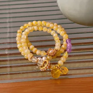 Double-layered citrine bracelet with pearls and a gold 'Fu' lucky pendant in neo-Chinese style