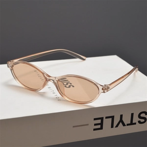 Detail view of oval retro sunglasses with champagne resin frames and light brown lenses