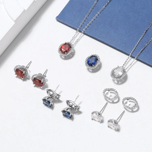 Detailed halo set featuring oval cut ruby, sapphire, and clear zircon jewelry in silver