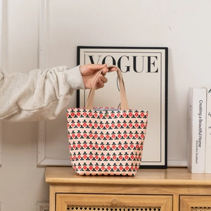 Detail of floral corduroy tote bag showing metal snap closure and durable woven handles