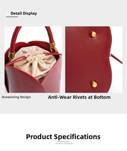Detail view of red petal bucket bag showing the drawstring lining and metal bottom studs