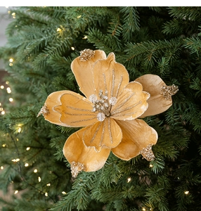 Macro shot of 22cm gold glitter Christmas magnolia flower with bead stamen on tree