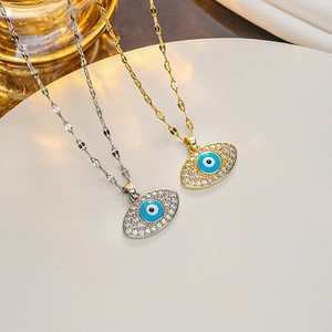 Detailed view of gold and silver Evil Eye pendant necklaces with blue enamel and crystals