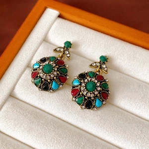 Close-up of vintage jewelry set with multi-colored gemstones in a premium gift box