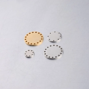 Close-up of assorted gold and silver stainless steel multi-hole round jewelry discs