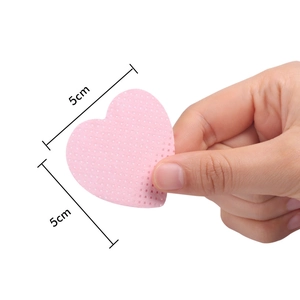 Detailed close-up of pink heart-shaped eyelash glue cleaning wipes measuring 5cm by 5cm