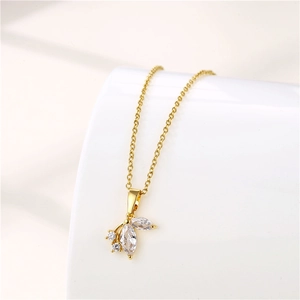 Detailed view of a gold-plated stainless steel leaf pendant with sparkling zircon crystals