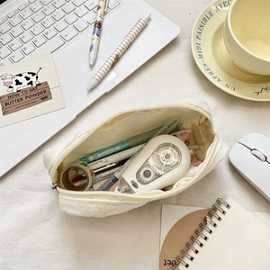 Large capacity cream canvas pencil case showing interior stationery storage and cute embroidery