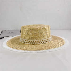 Straw sun hat with flat top, fringe edges and three-row pearl decorative band