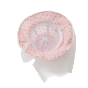 Pink lace baby sun hat with white mesh veil and pompom trim for toddlers