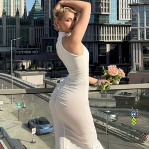 Detail of white sleeveless bodycon dress featuring elegant hip ruching and modal texture