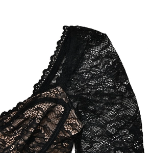 Close-up of black floral lace detailing on the shoulder and sleeve of a slim bodysuit