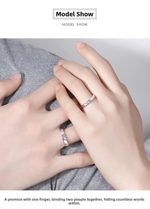 Close-up of minimalist silver couple rings with inlaid diamond on the female band