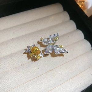 Detailed macro of a silver butterfly ring with yellow zircons on a luxury jewelry box