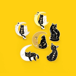 Creative black cat and moon enamel pin set with celestial star patterns on yellow backdrop